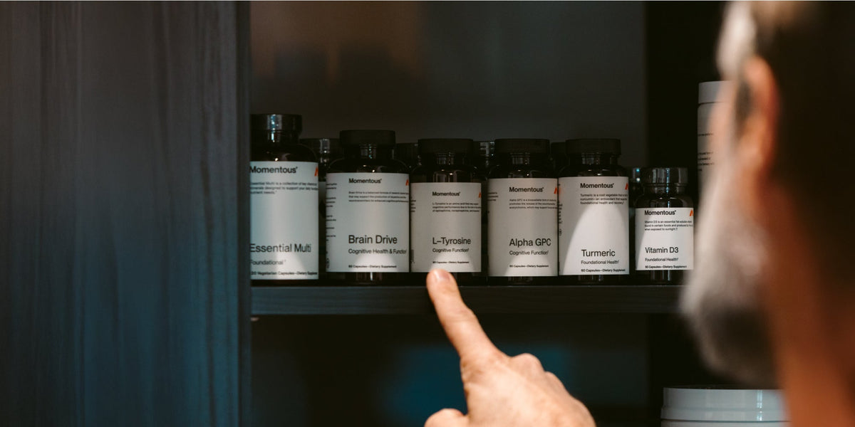 person choosing which vitamin they are going to take