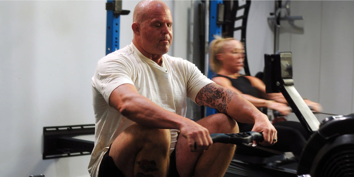 A man and woman moving heavy weights