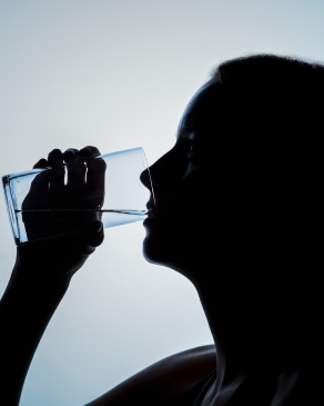 Silhouette of a person drinking from a glass representing Momentous Creatine's unrivaled testing protocol, which tests for PFAS, microplastics, and heavy metals resulting in 10x fewer impurities than other premium creatine brands