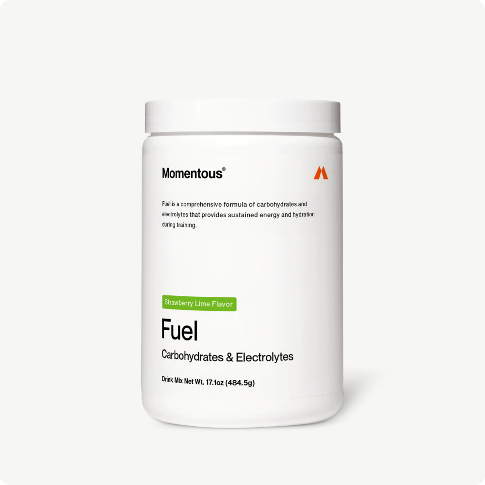 White plastic container labeled “Momentous Fuel – Carbohydrates & Electrolytes” in Strawberry Lime flavor. Text states that Fuel is a comprehensive formula of carbohydrates and electrolytes that provides sustained energy and hydration during training. Net weight: 17.1 oz (484.5 g).