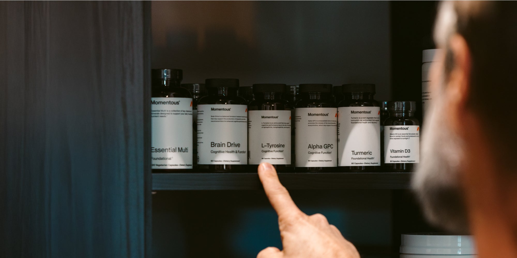 person choosing which vitamin they are going to take