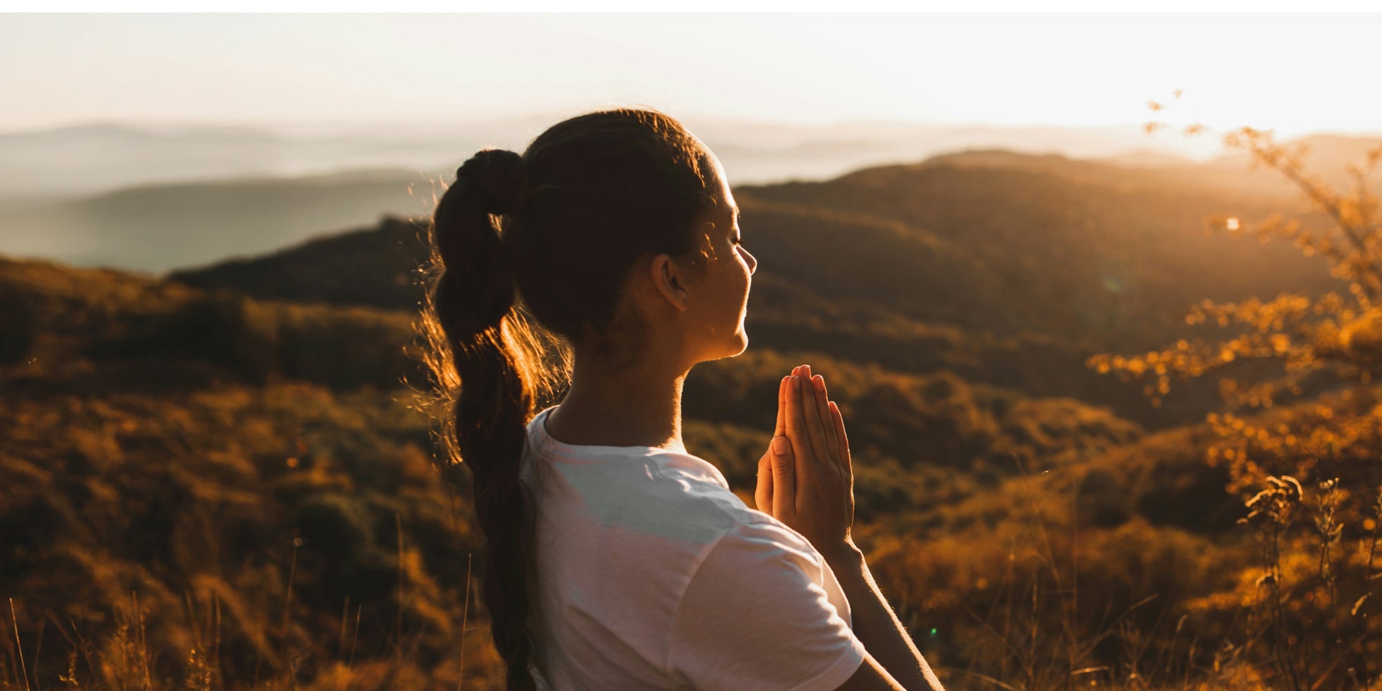 Woman on a hillside meditating