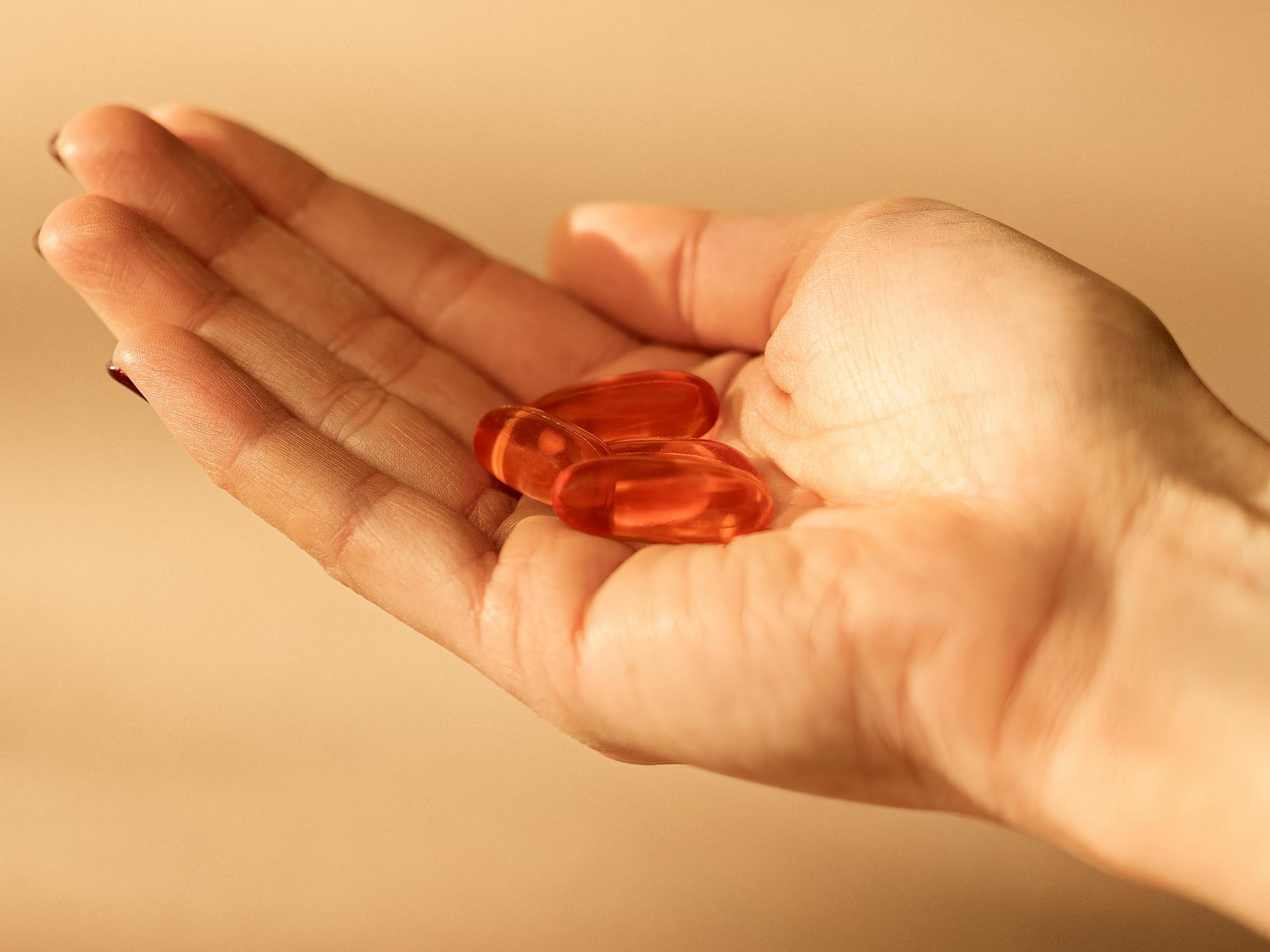 Vegan Omega-3 capsules in a woman's hand
