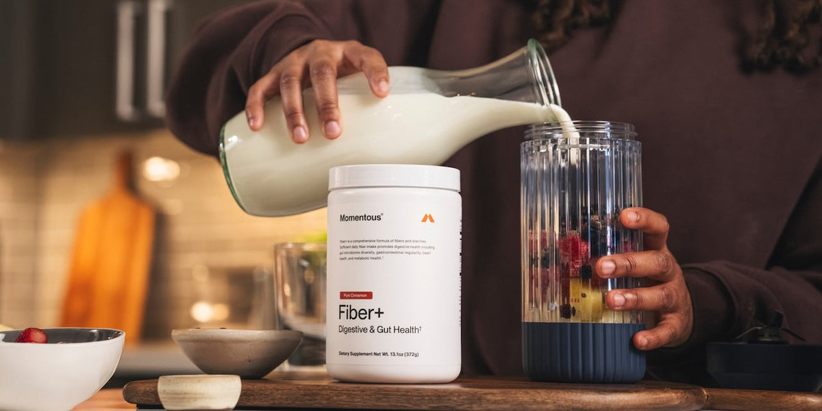 A tub of Momentous Creatine Chews in the side pocket of someone's bag