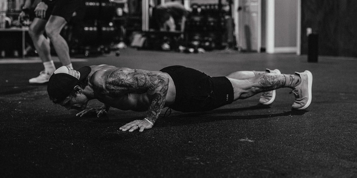 an athlete does a push up in the gym