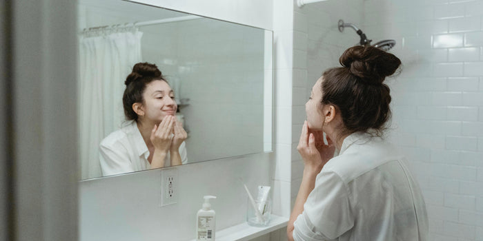 A woman looks in the mirror