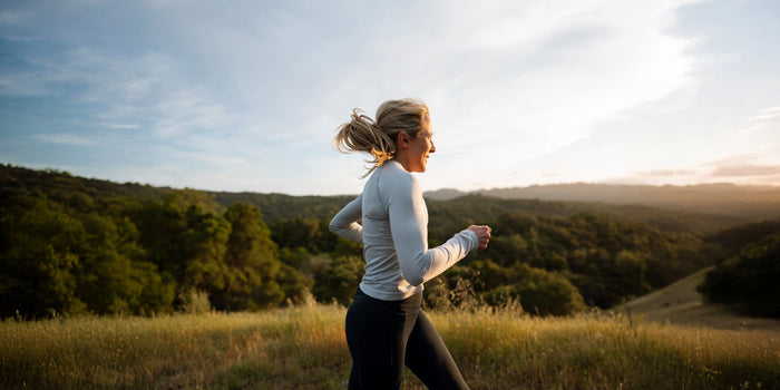 A middle-aged woman runs along a trail