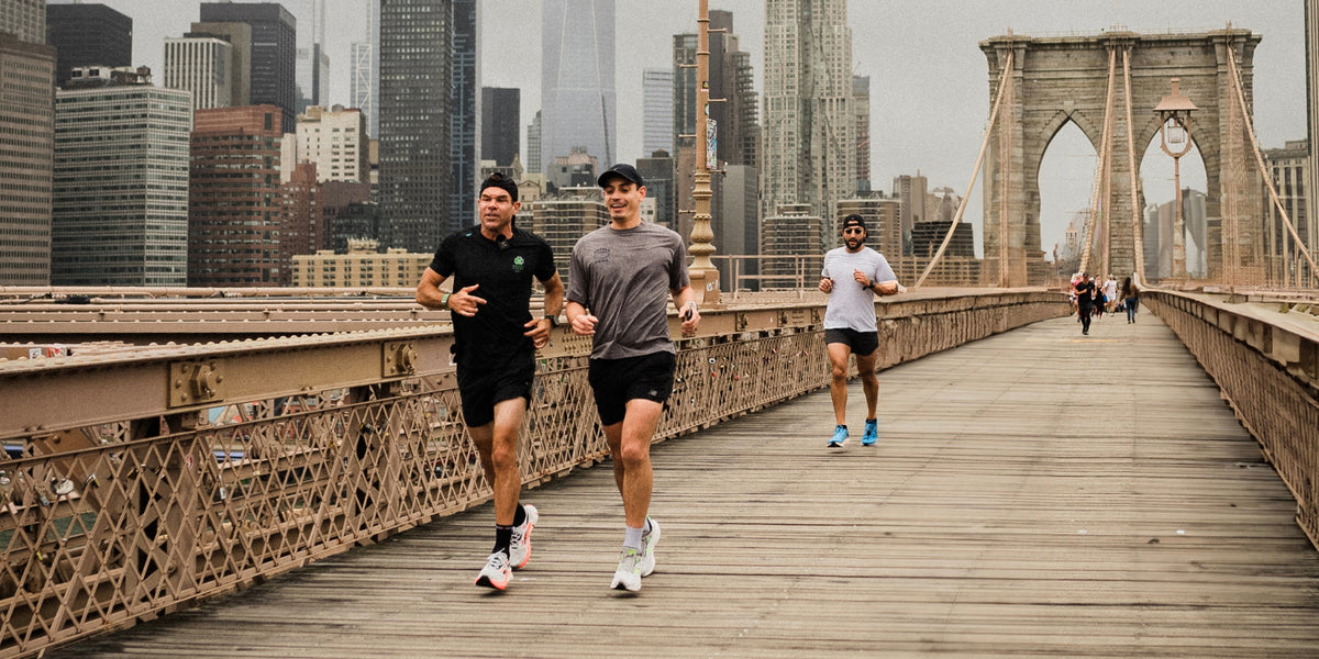 Ken Rideout runs across a Brooklyn bridge with another man