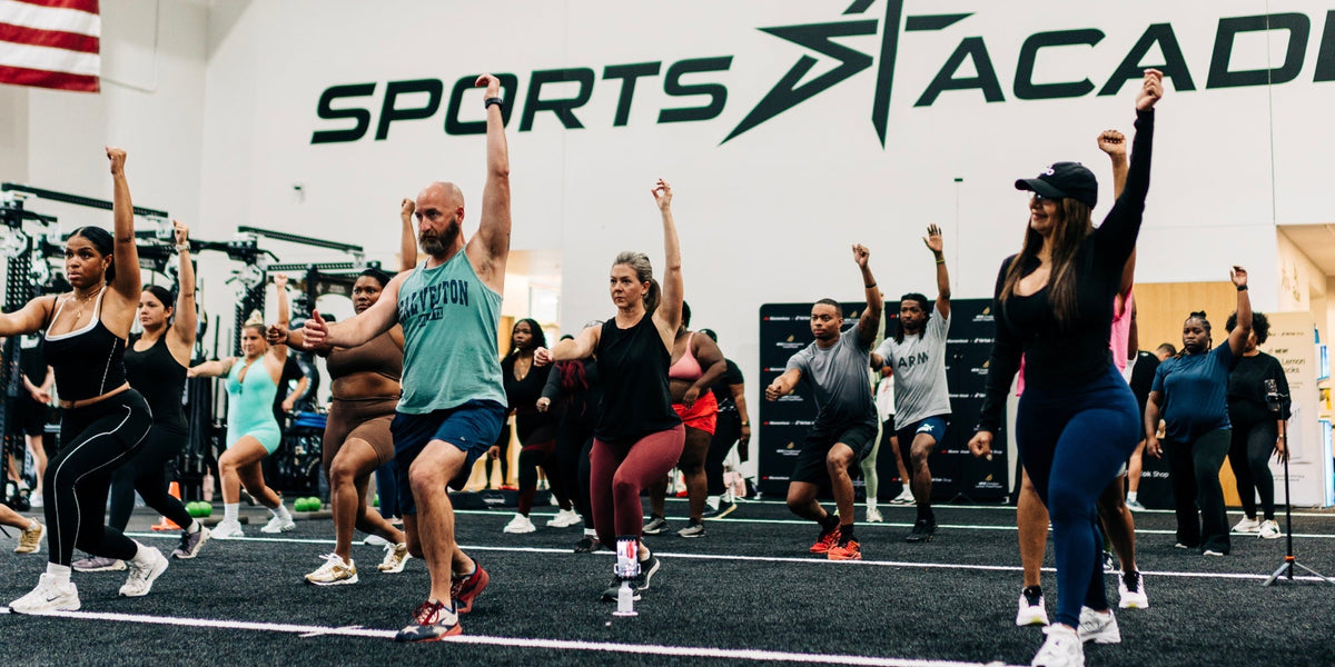 men and women work out during a group exercise class