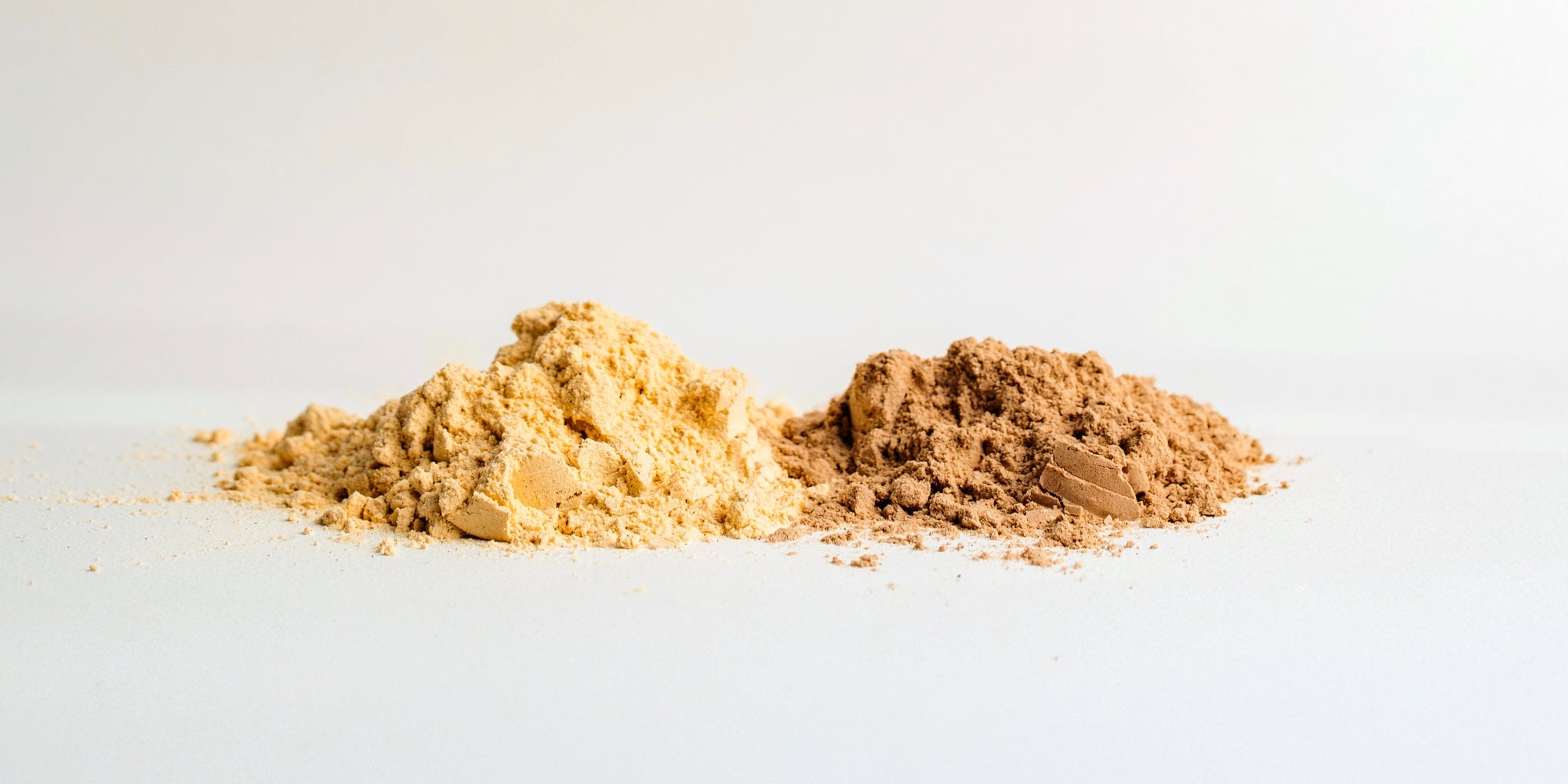 Two scoops of light brown protein powder