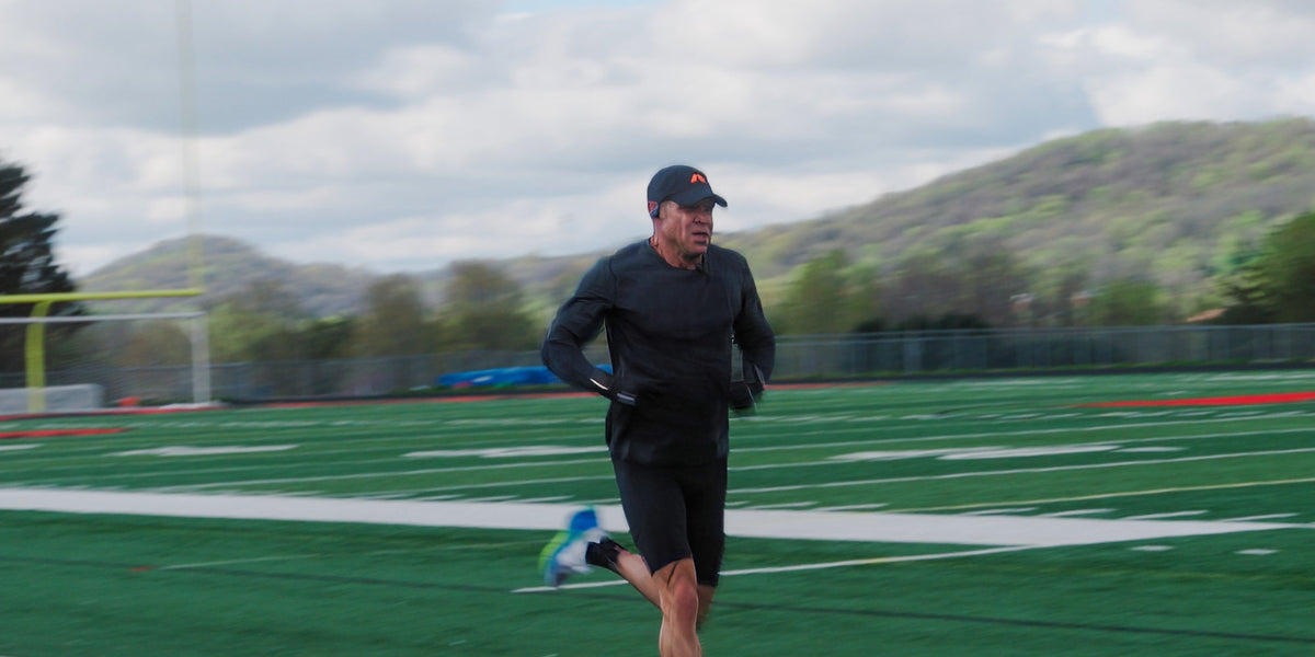 Athlete Ken Rideout running on the track