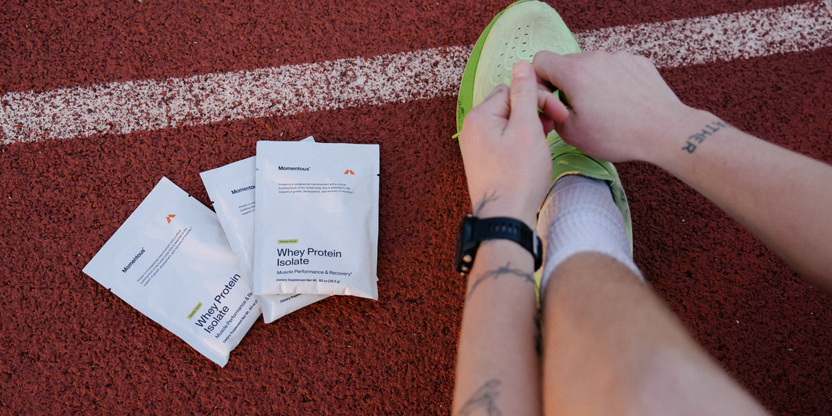 athlete with whey protein isolate travel packs at the track