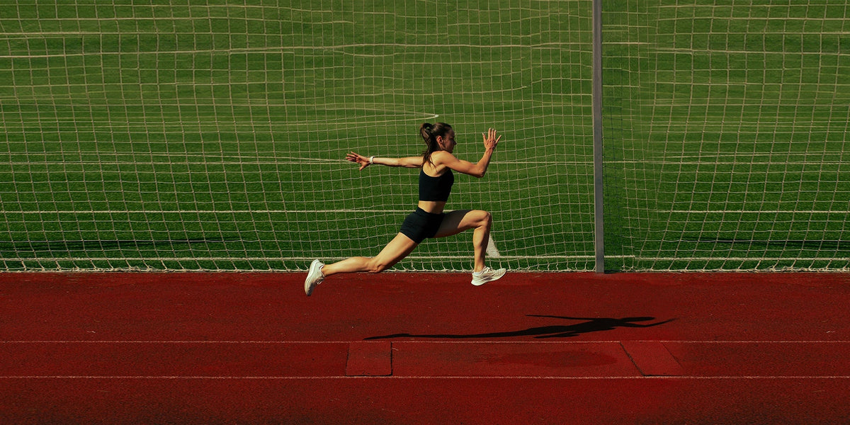 A female athlete sprints down a track