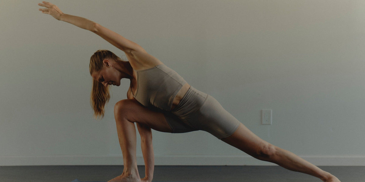 An athletic woman does a side stretch
