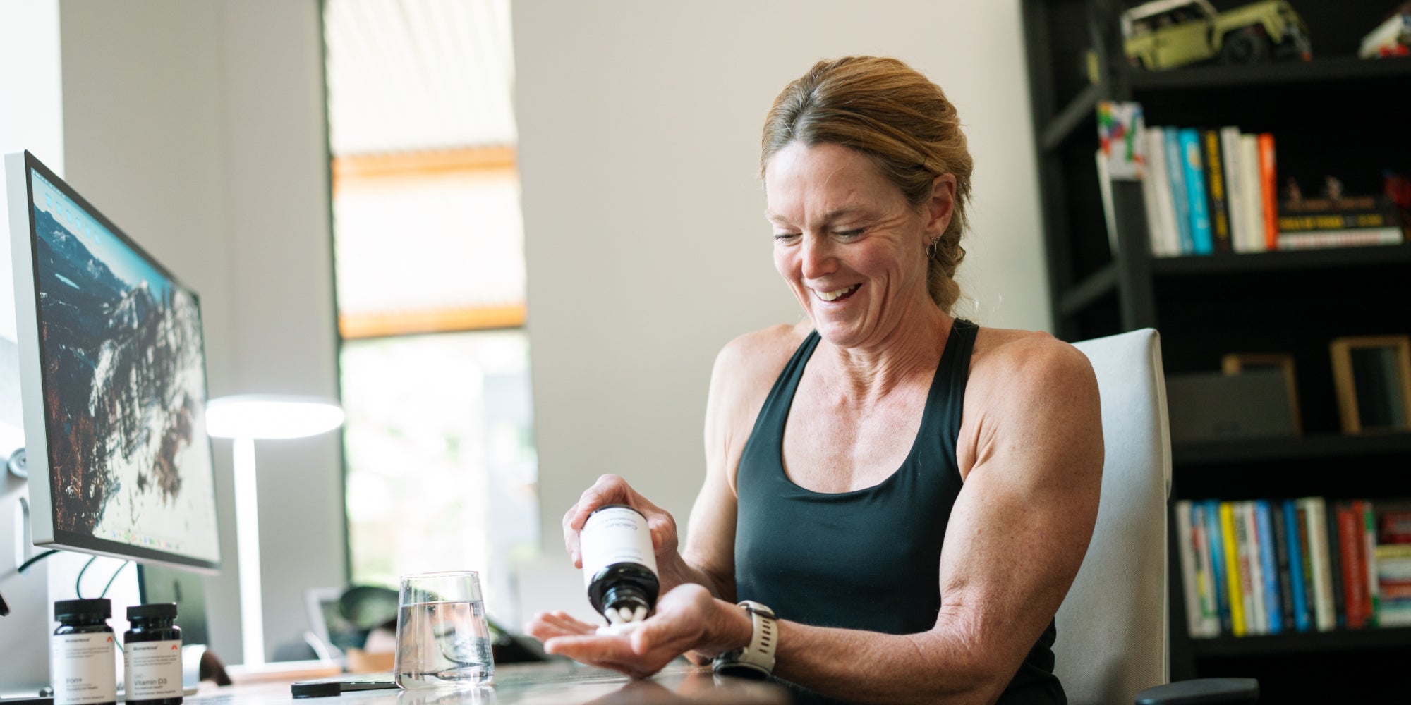 woman pouring supplements in hand 