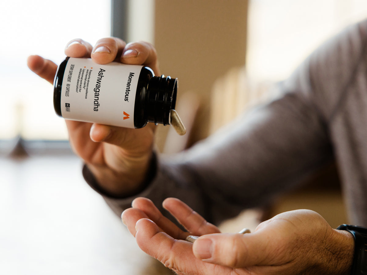 1. Momentous Ashwagandha, 60 capsules, tipped from the bottle into an open palm in bright window light: supports stress resilience and mental clarity, liposomal extract for enhanced absorption, dietary supplement, NSF Certified Sport.  (231 chars)