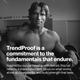Black-and-white photo of Arnold Schwarzenegger in a gym environment. Large white overlay text reads: “TrendProof is a commitment to the fundamentals that endure.” Smaller text below reads: “Inspired by our partnership with Arnold, this hat reflects a shared standard: focus on what works, show up consistently, and build strength that lasts.” Arnold is shown shirtless holding a weight plate with gym equipment visible in the background.