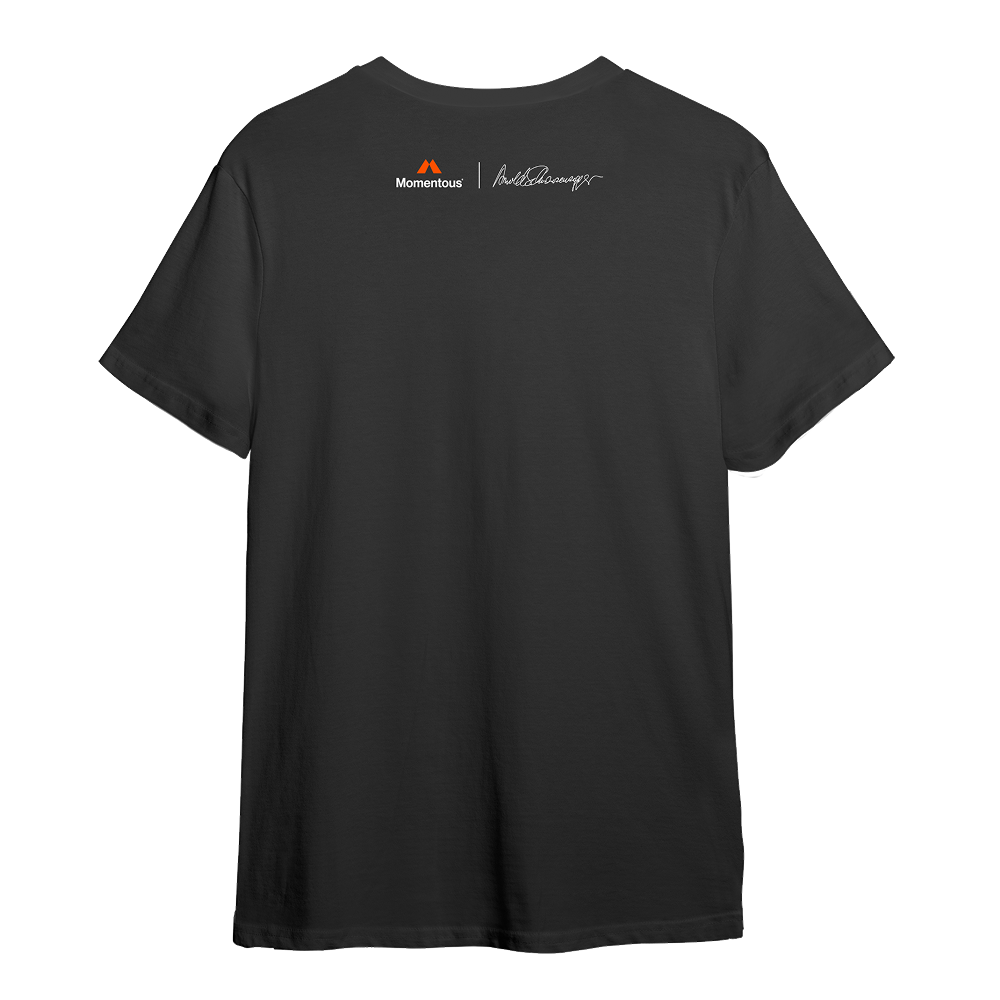 Back view of a charcoal gray athletic T-shirt with a clean, minimal design. Centered high across the upper back is a small orange Momentous logo and wordmark. To the right of it is a white signature graphic, referencing Arnold Schwarzenegger. The shirt has short sleeves and a straight hem, maintaining a sleek performance fit.