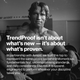 Black-and-white archival-style photograph of Arnold Schwarzenegger in a gym setting, shown from the waist up with muscular build, slightly sweaty hair, and intense expression. He stands shirtless holding a weight plate, conveying strength and discipline. Overlaid white text reads: “TrendProof isn’t about what’s new — it’s about what’s proven.” Below, smaller text explains the collaboration with Arnold and Momentous, emphasizing fundamentals, uncompromising standards, and daily consistency.