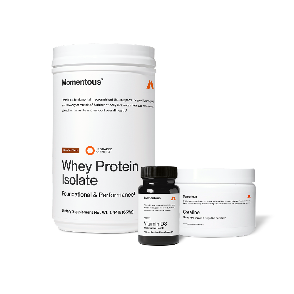 Product image of Momentous Whey Protein Isolate in chocolate flavor shown with Vitamin D3 and Creatine tubs.