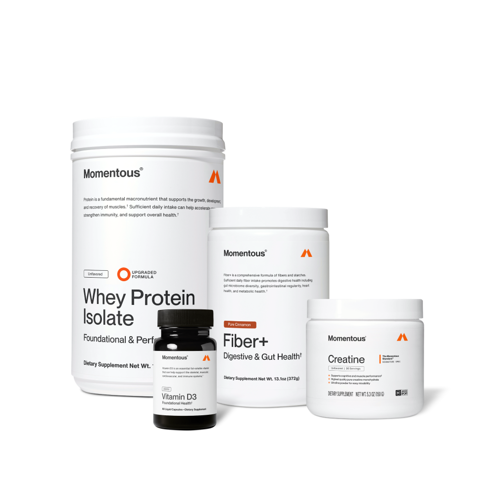 Four Momentous products on black background: Whey Protein Isolate – Unflavored, Upgraded Formula, Foundational & Performance; Vitamin D3 – 2000IU, Foundational Health, 60 Liquid Capsules; Fiber+ – Pure Cinnamon, Digestive & Gut Health, 13.1oz (372g); Creatine – Signature Spec, Unflavored, 30 Servings, 5.3oz (150g), NSF Certified for Sport.