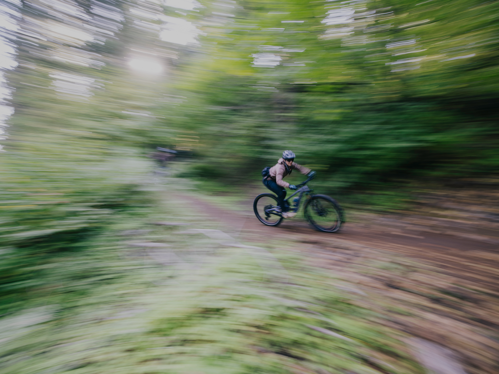 Cyclist riding through a forest trail with motion blur, representing endurance and metabolic efficiency supported by Berberine.