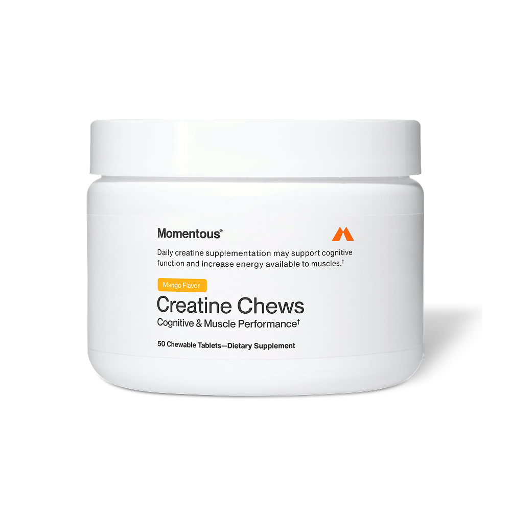White container of Momentous Creatine Chews Mango Flavor displayed against a white background. The label features the Momentous brand name and orange “M” logo, with a description that daily creatine supplementation may support cognitive function and increase energy available to muscles. An orange label indicates “Mango Flavor.” The product title reads “Creatine Chews” with the benefit line “Cognitive & Muscle Performance.” The jar contains 50 chewable tablets.