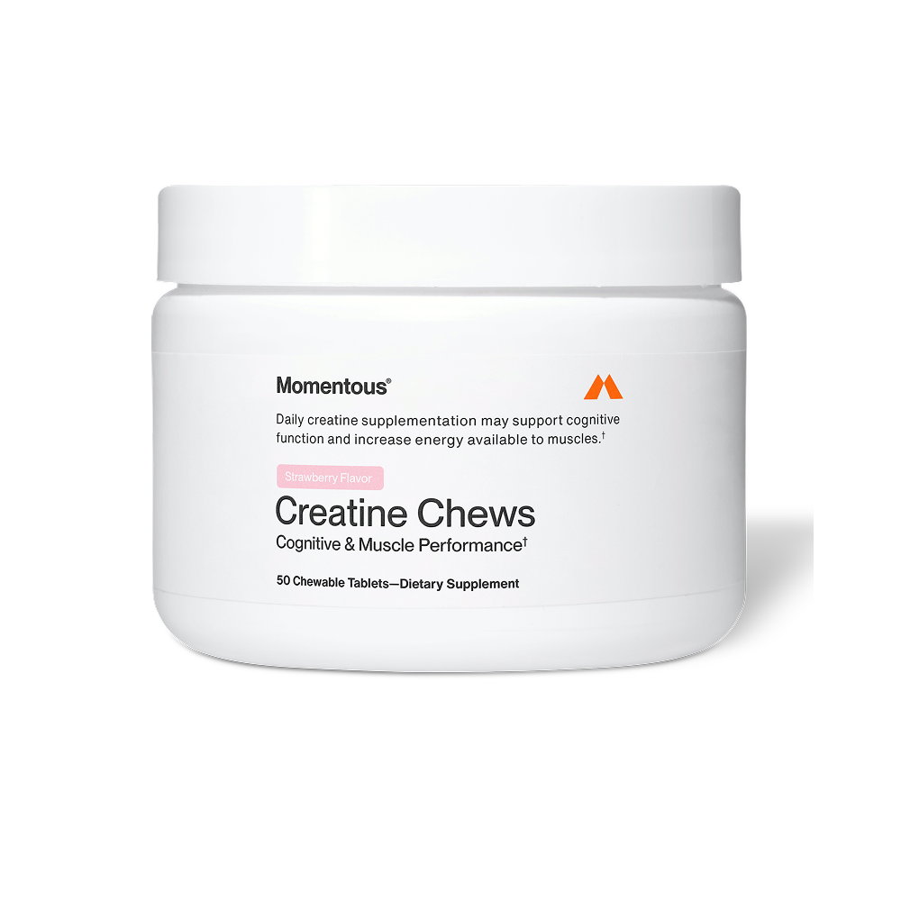 White plastic jar of Momentous Creatine Chews dietary supplement with a matte white lid on a clean white background. The label reads “Momentous” with the orange Momentous “M” logo and states “Daily creatine supplementation may support cognitive function and increase energy available to muscles.” A pink tag indicates “Strawberry Flavor.” The product name “Creatine Chews” appears in large black text with the subtitle “Cognitive & Muscle Performance.” The bottom of the label reads “50 Chewable Tablets — Dietar