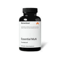 Black bottle of Momentous Essential Multi capsules centered on a transparent background. Text on the label reads: “Momentous®” “Essential Multi is a collection of key vitamins and minerals designed to support your daily foundational nutrient needs.*” “Essential Multi” “Foundational†” “120 Capsules—Dietary Supplement”