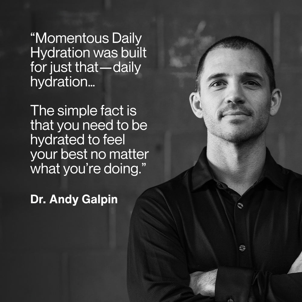 Dr. Andy Galpin standing arms crossed against a dark stone wall, beside his quote: Momentous Daily Hydration was built for just that, daily hydration. The simple fact is that you need to be hydrated to feel your best no matter what you're doing. (245 chars)