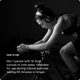 Black-and-white photo of a woman wearing headphones while riding an indoor bike trainer, leaning forward in an intense workout. White text on the left side reads: 'HOW TO USE — Mix 1 packet with 16 fluid ounces of cold water. Intended for use during intense exercise lasting 60 minutes or longer.