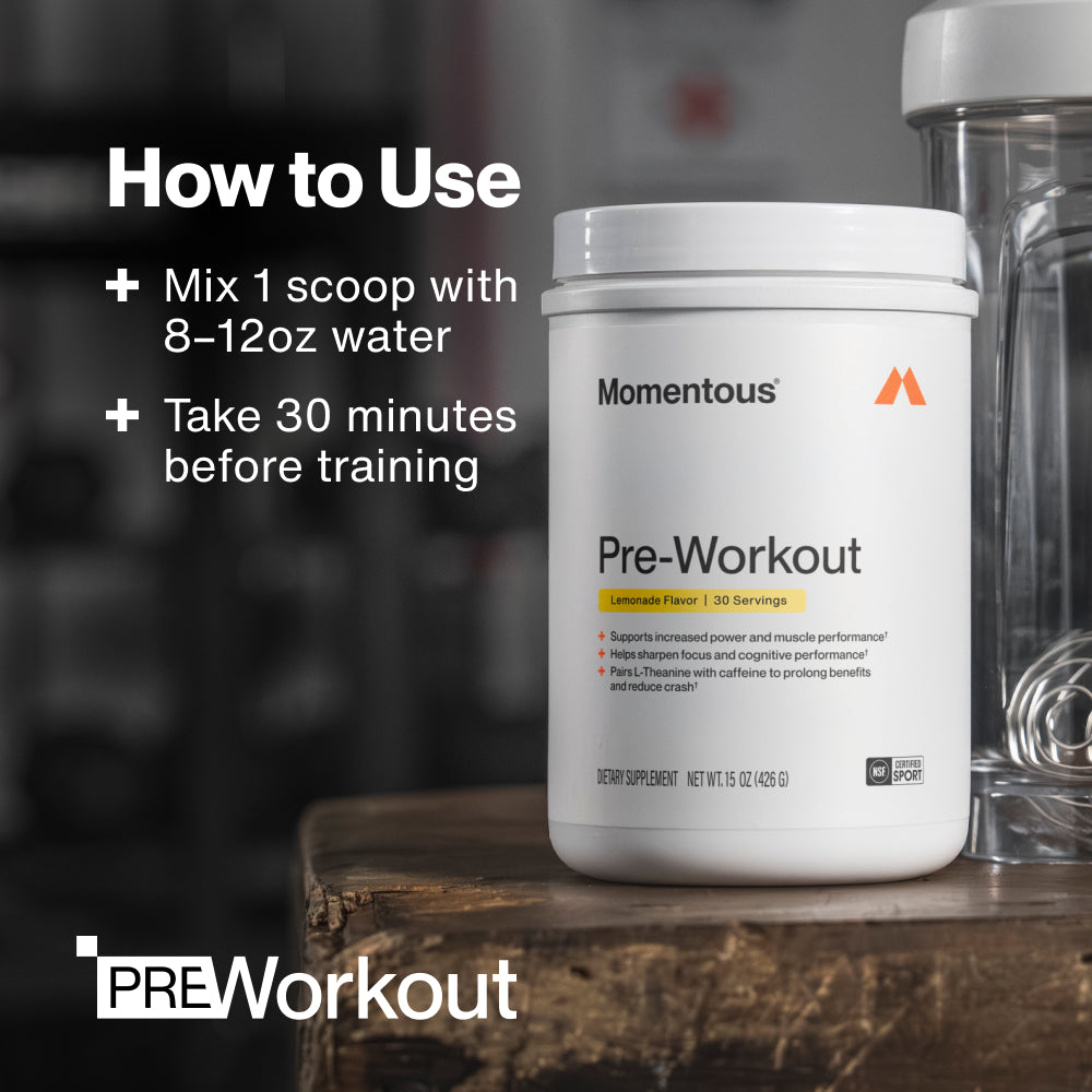 How to use Momentous Pre-Workout: mix 1 scoop with 8 to 12oz water and take 30 minutes before training, with the Lemonade 30 servings tub beside a clear shaker bottle on a wooden bench in a dark gym, PRE Workout wordmark in the corner. (235 chars)