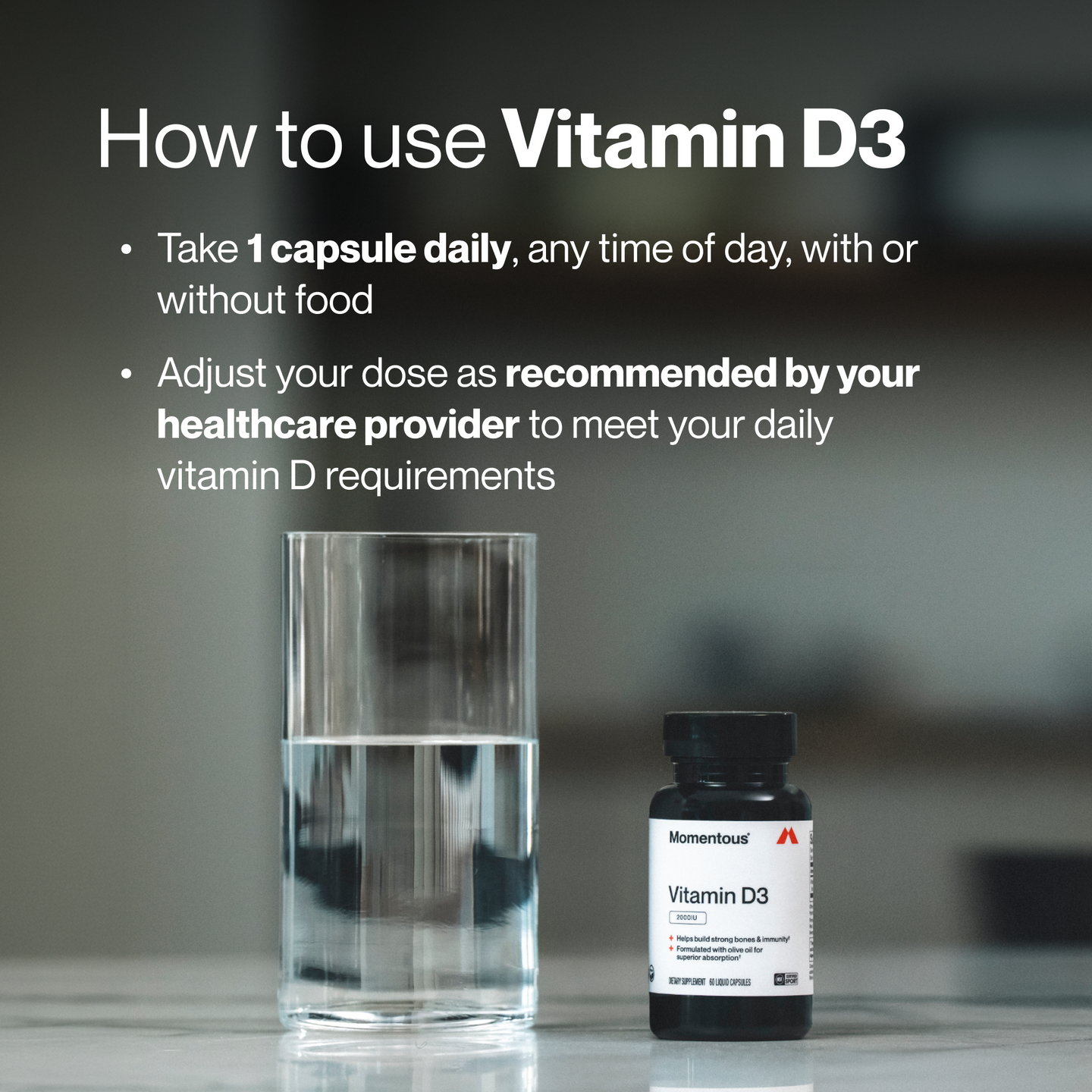 Dark blurred background image with a glass of water and a black Momentous Vitamin D3 bottle. Text: 