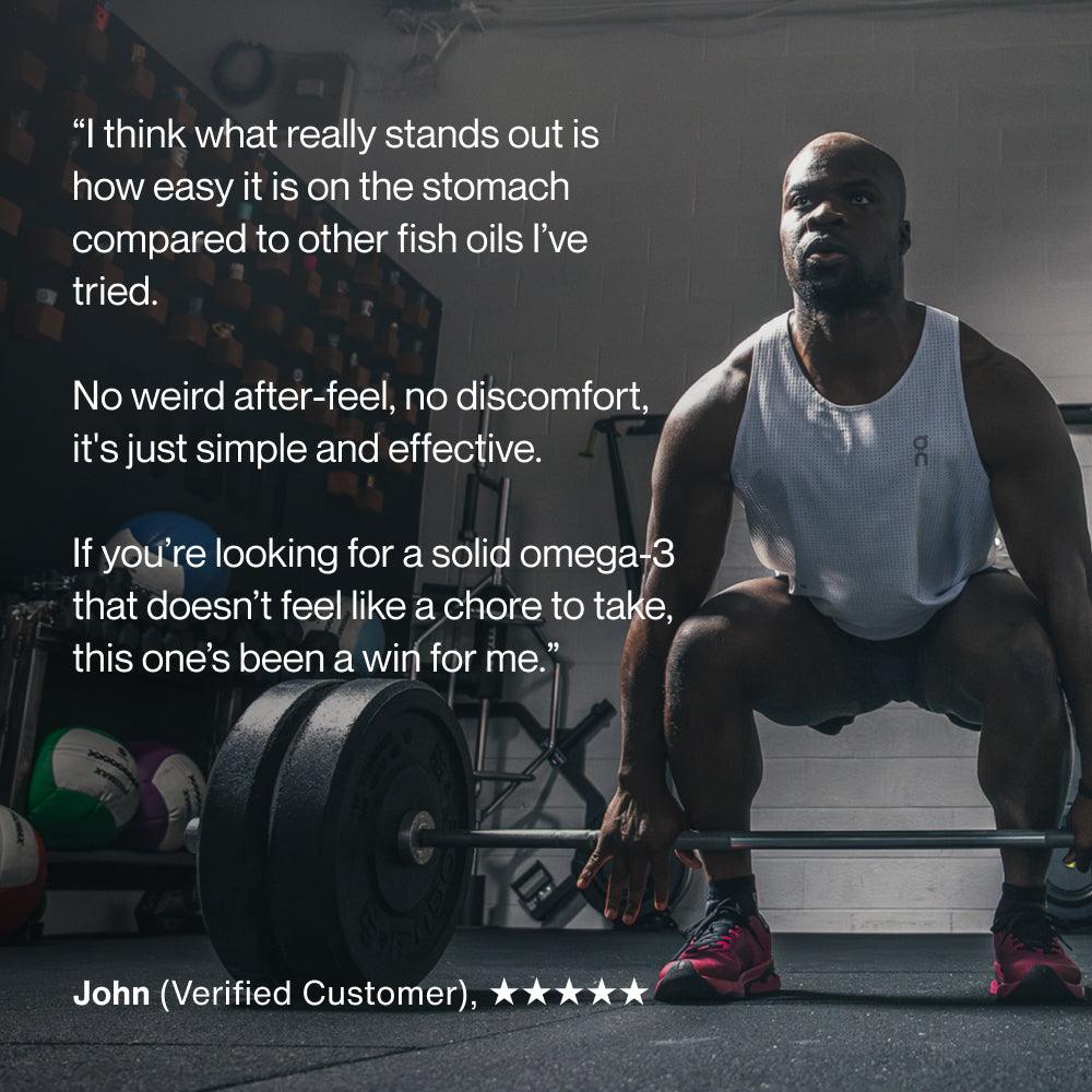 A muscular man in a gym performs a deadlift with a barbell, wearing a white tank top and red shoes, with weight plates and gym equipment in the background. Text on the image reads: “I think what really stands out is how easy it is on the stomach compared to other fish oils I’ve tried. No weird after-feel, no discomfort, it’s just simple and effective. If you’re looking for a solid omega-3 that doesn’t feel like a chore to take, this one’s been a win for me.” John (Verified Customer), ★★★★★