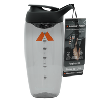 Clear shaker bottle with black lid, orange triangle logo, measurement markings, and attached instruction tag.