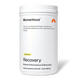 White Momentous Recovery container labeled “Vanilla Flavor.” Text reads: “Momentous. Recovery is a balanced formula of proteins and carbohydrates designed to aid in rapid recovery after training. Recovery. Muscle Performance & Recovery†. Dietary Supplement Net Wt. 1.32 lb (600 g).”