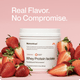 “Real Flavor. No Compromise. Momentous Whey Protein Isolate strawberry tub surrounded by strawberries.”